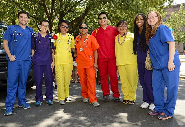 A group of nurses in rainbow scrubs
